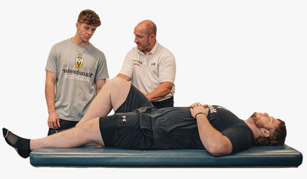 Professor Jeff Beer demonstrates proper technique during an exercise science lab.